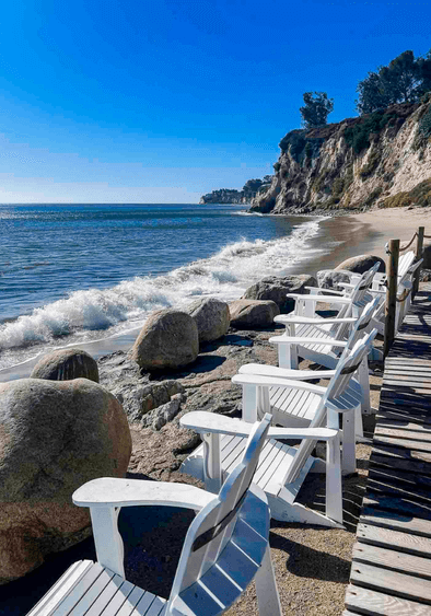 Paradise Cove Malibu. beach with surfer walking